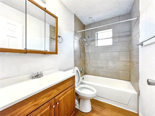 a bathroom with a sink a toilet and bathtub