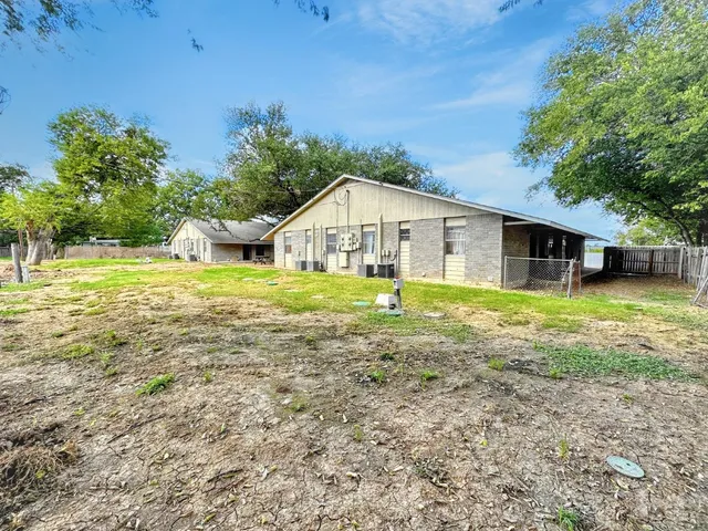 a view of a house with a yard and sitting area