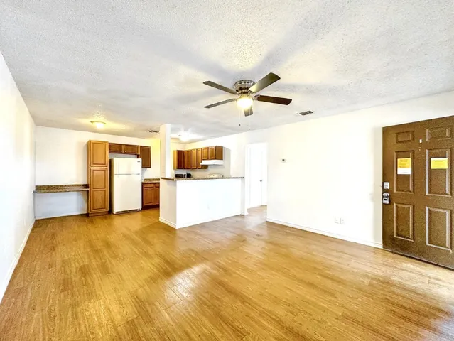 a view of a kitchen with wooden floor and window