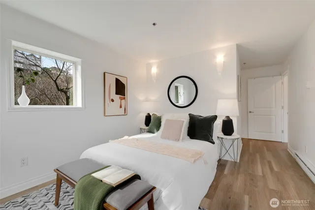 a bedroom with a bed and wooden floor