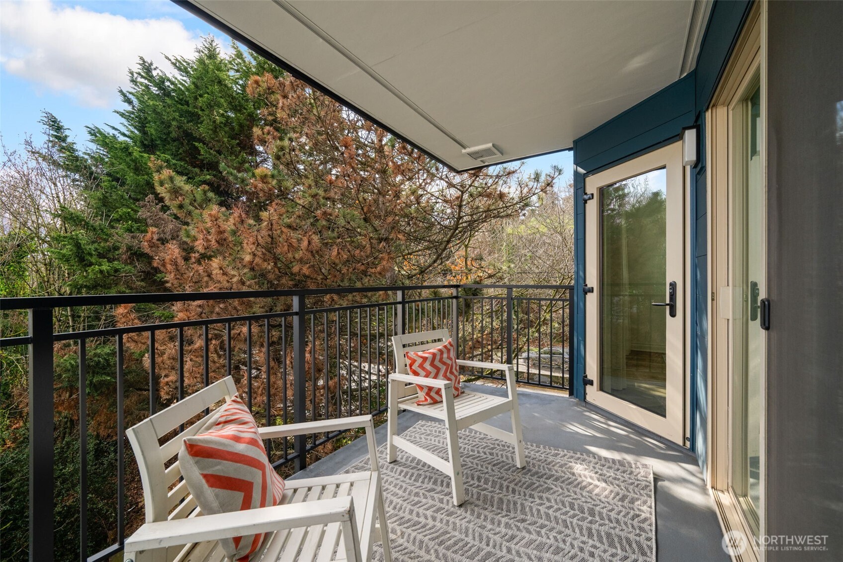 701 Galer Street, Unit 819 Seattle, WA 98109 - Photo 13 of 21 a balcony with wooden floor table and chairs