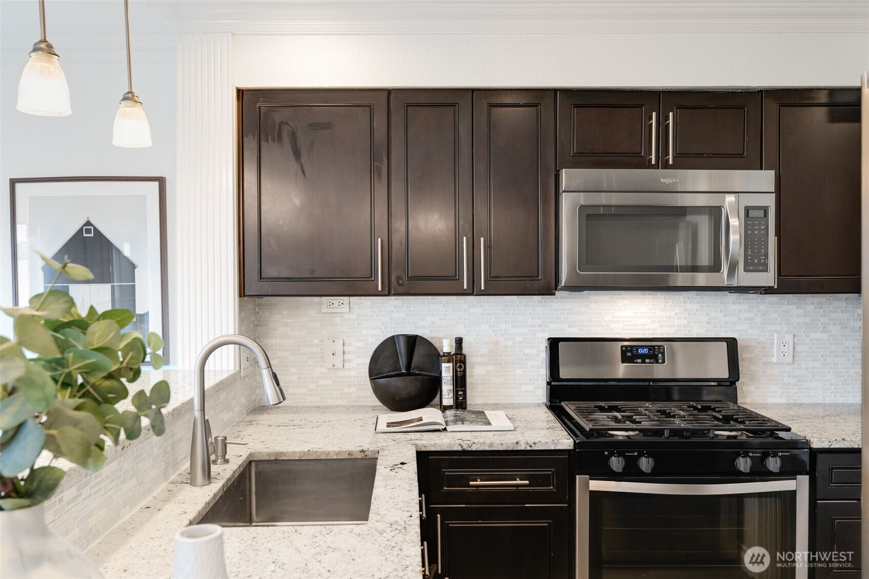 701 Galer Street, Unit 819 Seattle, WA 98109 - Photo 7 of 21 a kitchen with stainless steel appliances a stove and a microwave