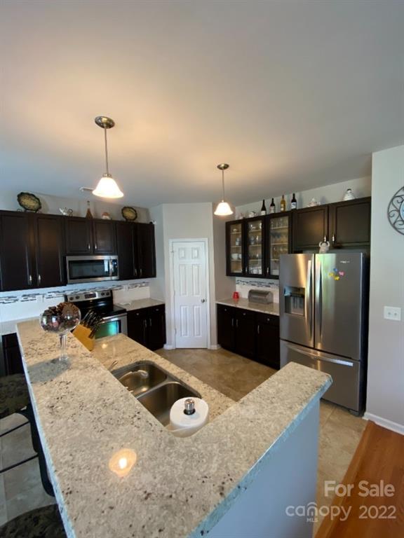 12014 Downy Birch Road, Unit 436 Charlotte, NC 28227 - Photo 11 of 26 a kitchen with stainless steel appliances granite countertop a sink refrigerator and cabinets