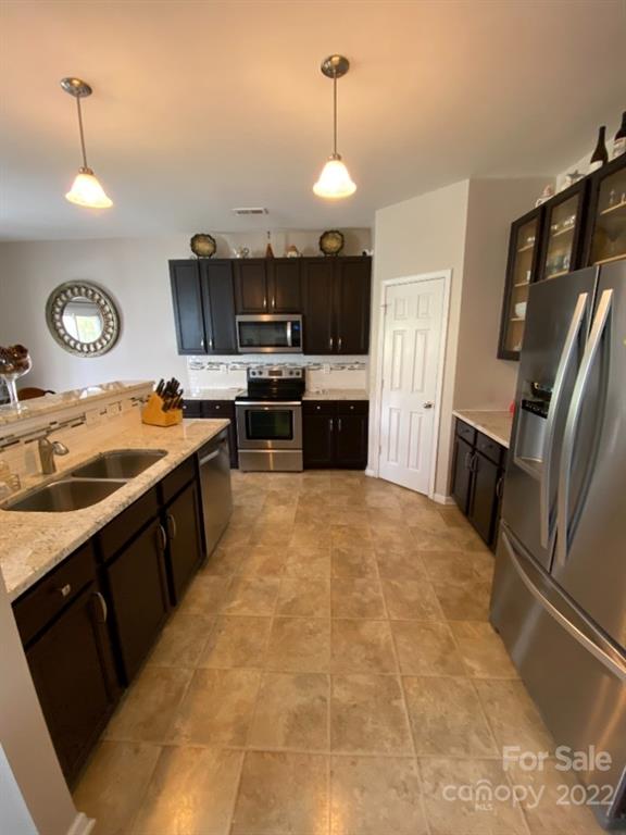 12014 Downy Birch Road, Unit 436 Charlotte, NC 28227 - Photo 12 of 26 a kitchen with stainless steel appliances a stove a sink and a refrigerator