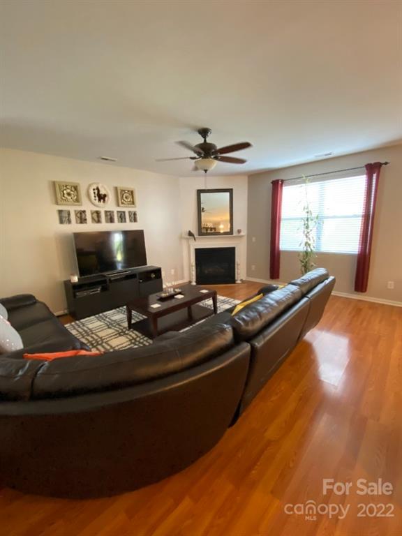 12014 Downy Birch Road, Unit 436 Charlotte, NC 28227 - Photo 13 of 26 a living room with furniture and a flat screen tv