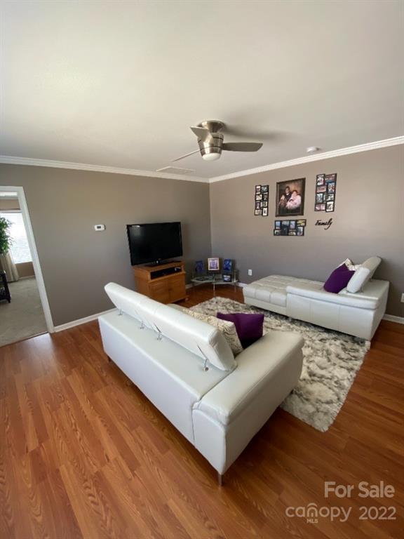 12014 Downy Birch Road, Unit 436 Charlotte, NC 28227 - Photo 16 of 26 a living room with furniture and a flat screen tv