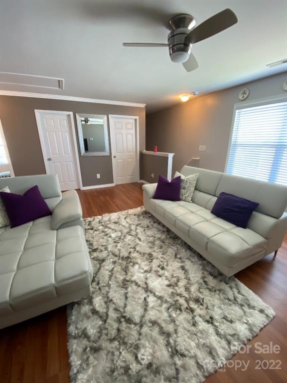 12014 Downy Birch Road, Unit 436 Charlotte, NC 28227 - Photo 17 of 26 a bedroom with a large bed and wooden floor