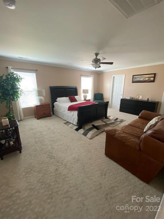 12014 Downy Birch Road, Unit 436 Charlotte, NC 28227 - Photo 19 of 26 a spacious bedroom with a bed and a couch