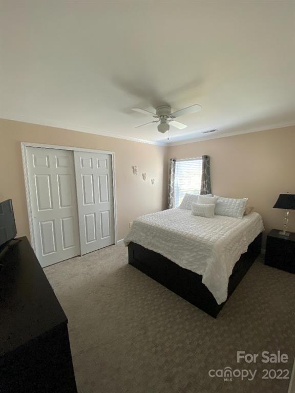 12014 Downy Birch Road, Unit 436 Charlotte, NC 28227 - Photo 21 of 26 a spacious bedroom with a bed and a window