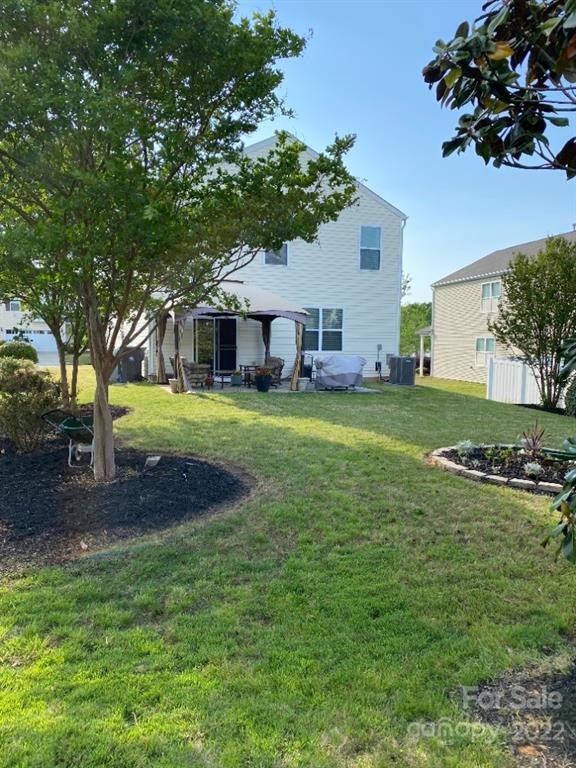 12014 Downy Birch Road, Unit 436 Charlotte, NC 28227 - Photo 4 of 26 a view of a house with a big yard and palm trees