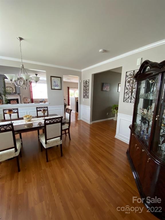 12014 Downy Birch Road, Unit 436 Charlotte, NC 28227 - Photo 6 of 26 a living room with furniture and a wooden floor