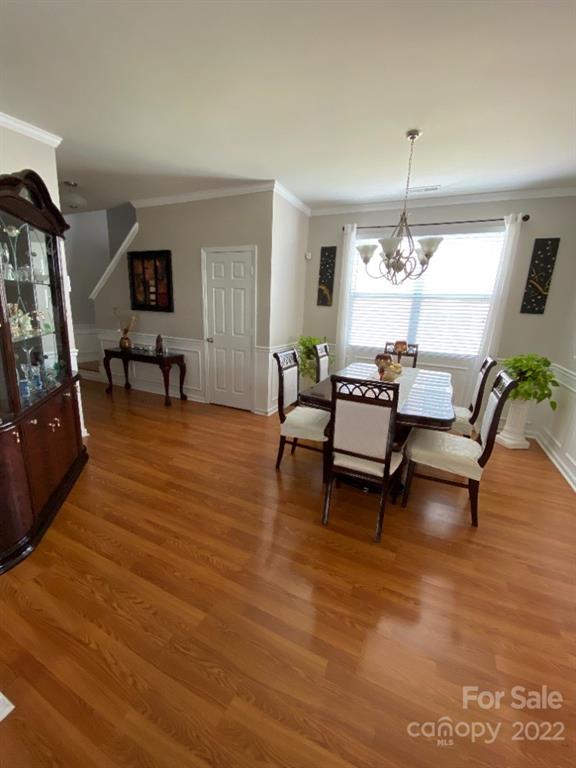 12014 Downy Birch Road, Unit 436 Charlotte, NC 28227 - Photo 7 of 26 a living room with furniture and a chandelier