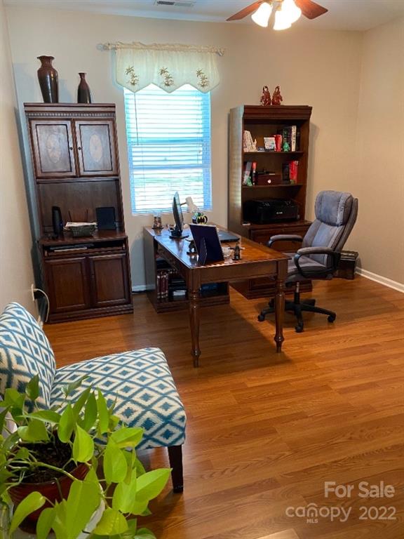 12014 Downy Birch Road, Unit 436 Charlotte, NC 28227 - Photo 8 of 26 a living room with furniture a rug and a bookshelf