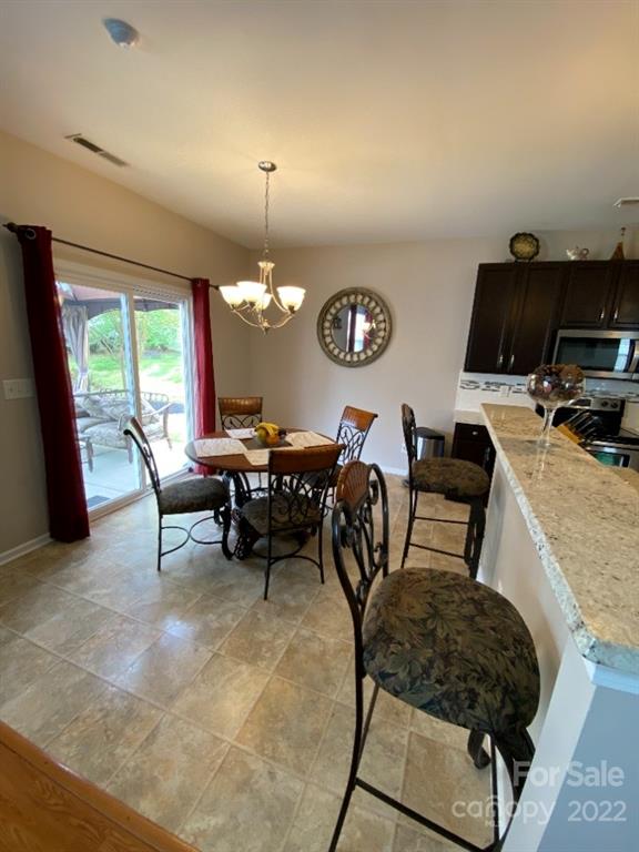 12014 Downy Birch Road, Unit 436 Charlotte, NC 28227 - Photo 10 of 26 a living room with furniture and a flat screen tv