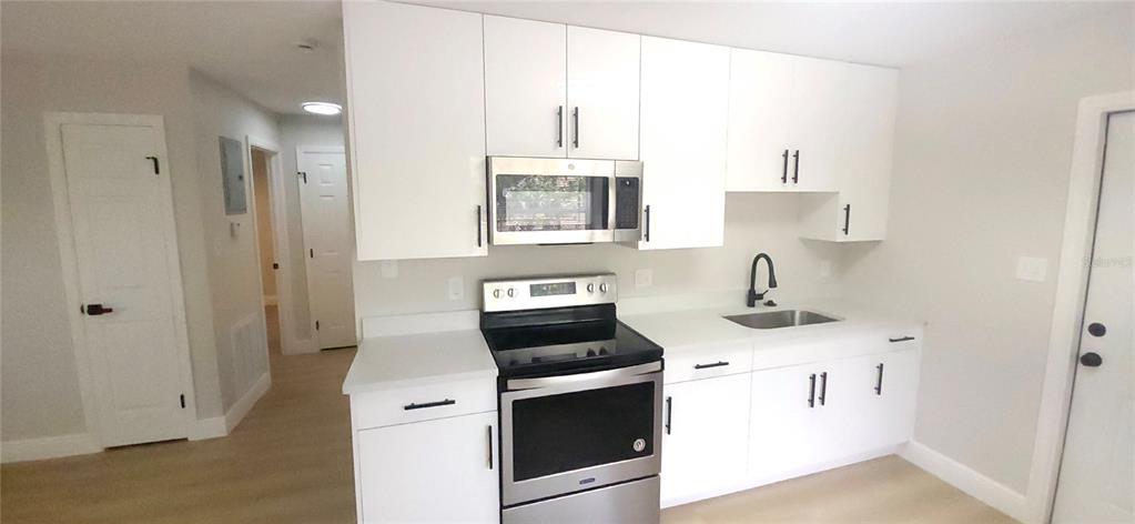 901 South Taylor Road Seffner, FL 33584 - Photo 4 of 13 a kitchen with a stove and a sink
