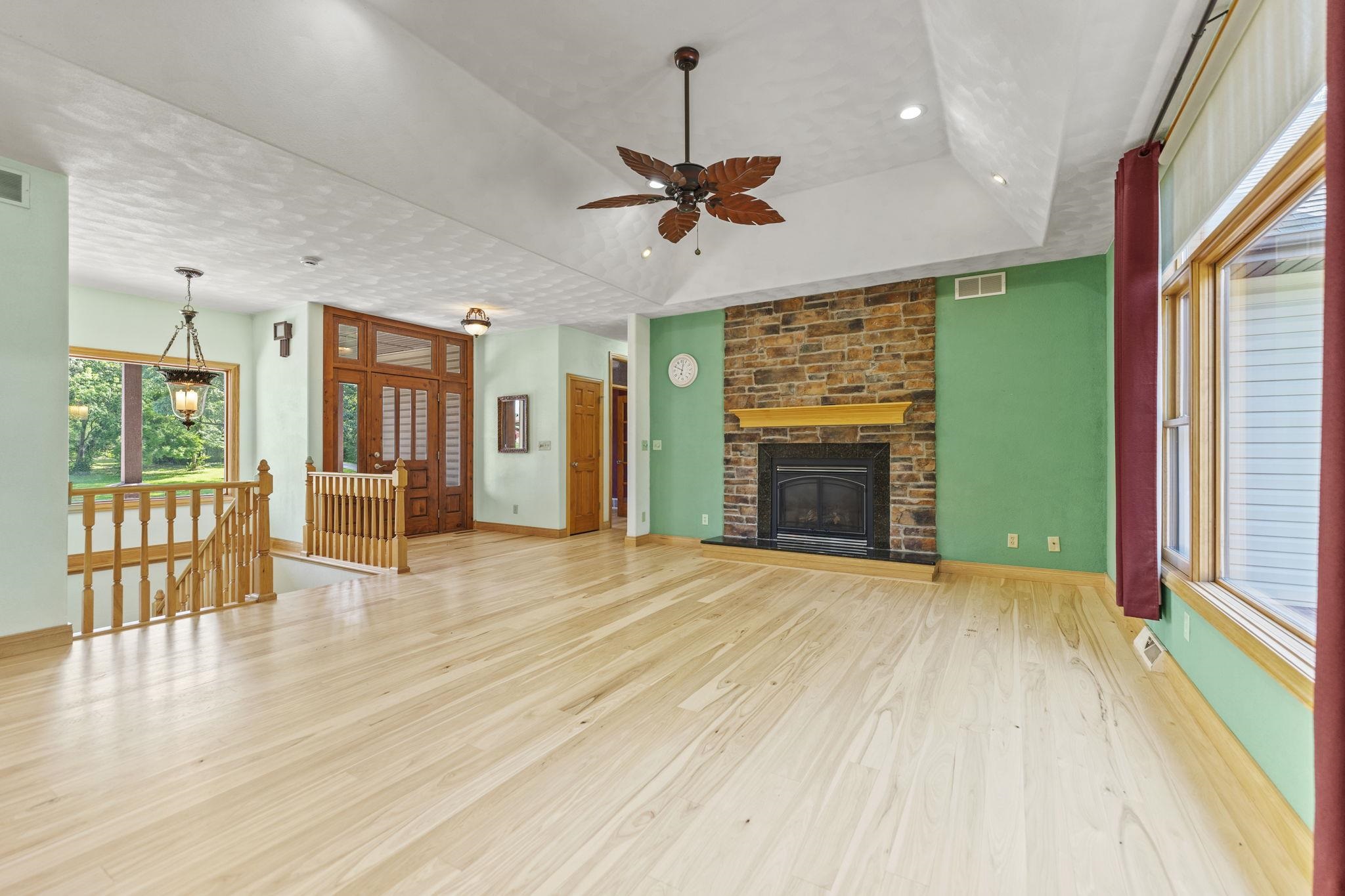 12830 Beloit Road Caledonia, IL 61011 - Photo 12 of 52 a view of an empty room with a fireplace and a window