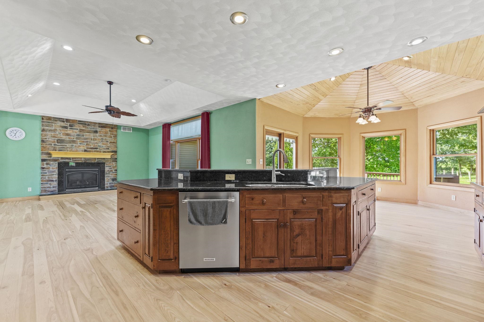 12830 Beloit Road Caledonia, IL 61011 - Photo 13 of 52 a large kitchen with stainless steel appliances granite countertop a large stove a sink dishwasher and a flat tv screen