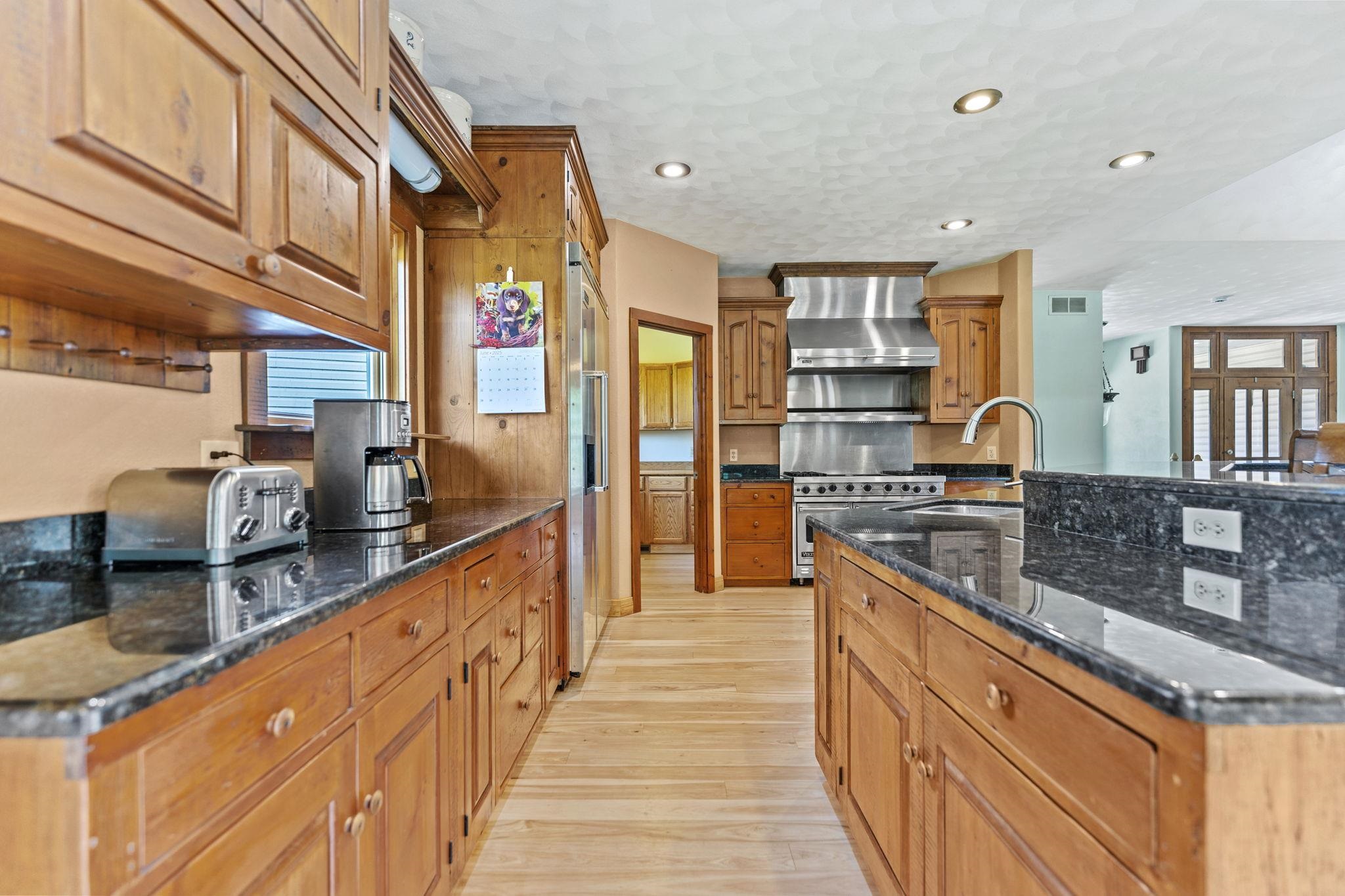 12830 Beloit Road Caledonia, IL 61011 - Photo 16 of 52 a kitchen with stainless steel appliances granite countertop a sink and cabinets