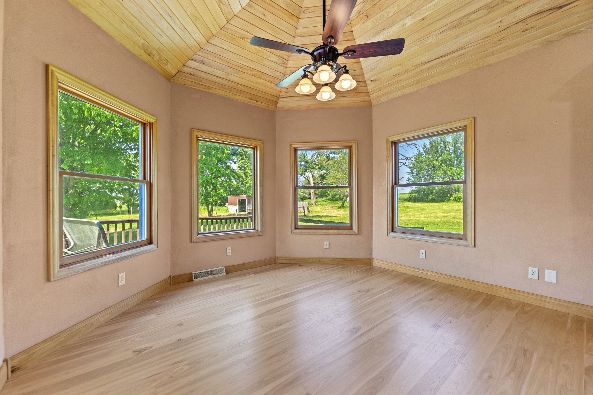 12830 Beloit Road Caledonia, IL 61011 - Photo 17 of 52 a view of an empty room with wooden floor and a window