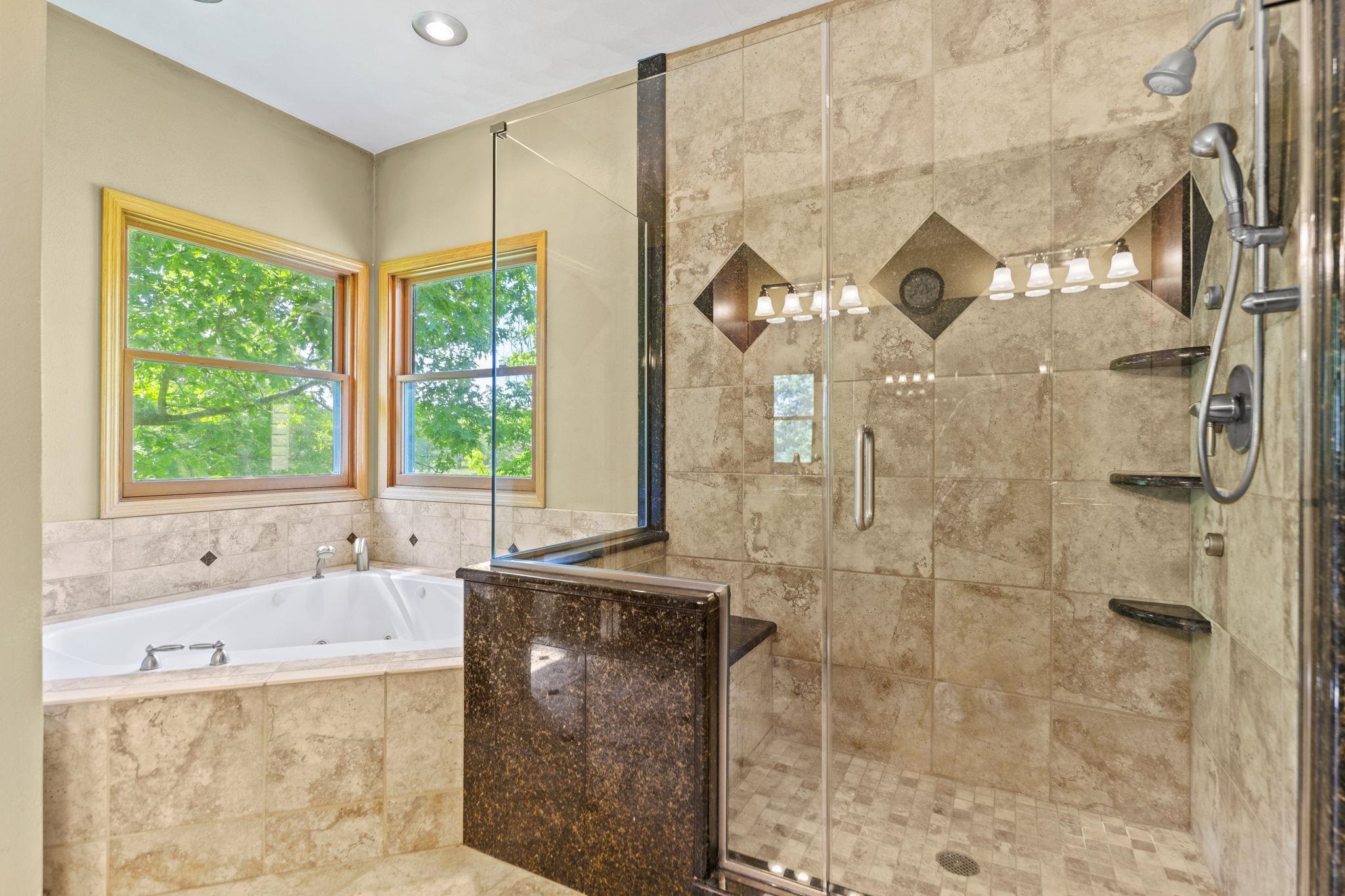 12830 Beloit Road Caledonia, IL 61011 - Photo 26 of 52 a bathroom with a granite countertop sink a bathtub and window