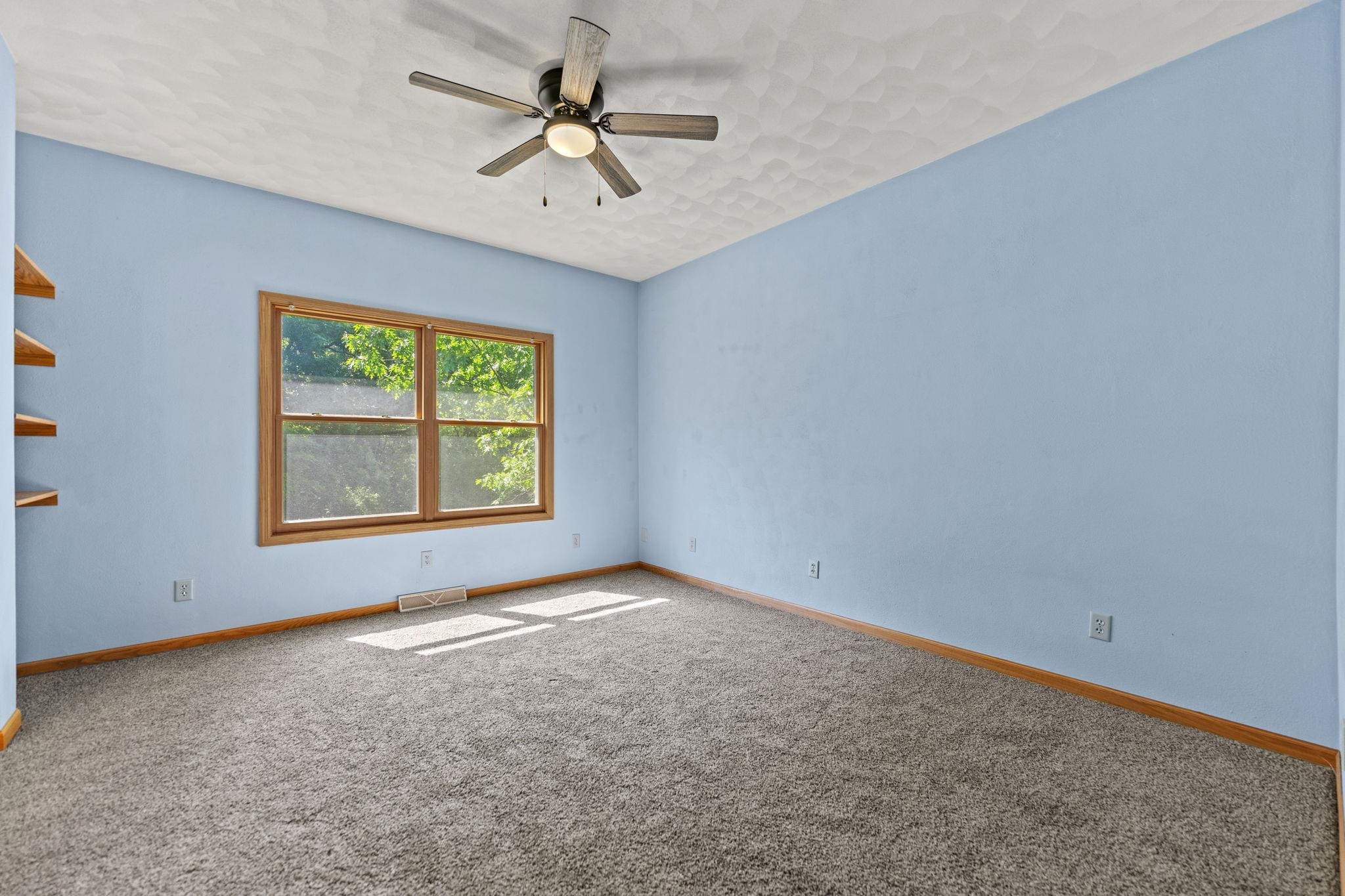 12830 Beloit Road Caledonia, IL 61011 - Photo 28 of 52 an empty room with windows and ceiling fan
