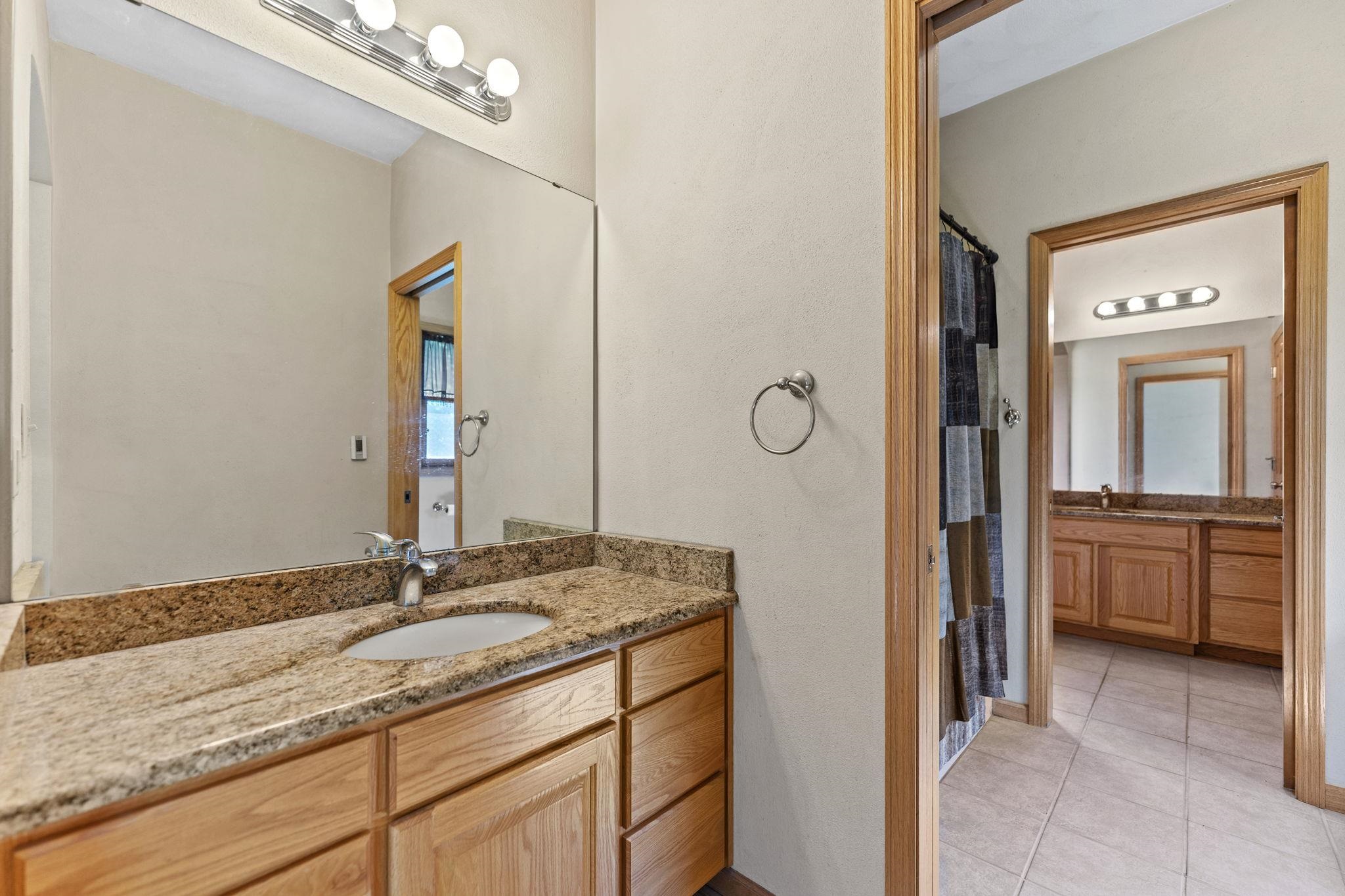 12830 Beloit Road Caledonia, IL 61011 - Photo 31 of 52 a bathroom with a granite countertop sink vanity and mirror