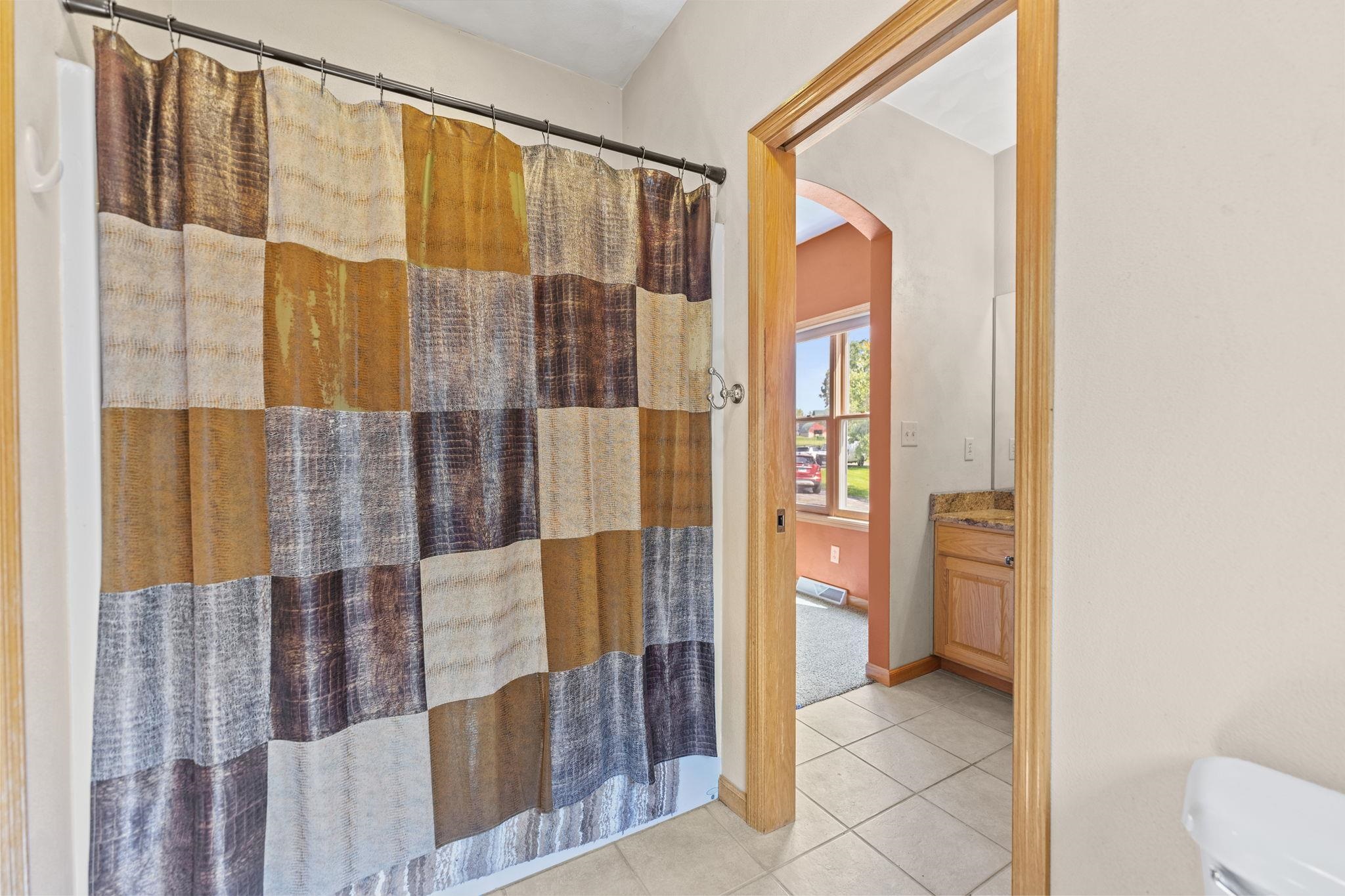 12830 Beloit Road Caledonia, IL 61011 - Photo 32 of 52 a bathroom with a glass shower door