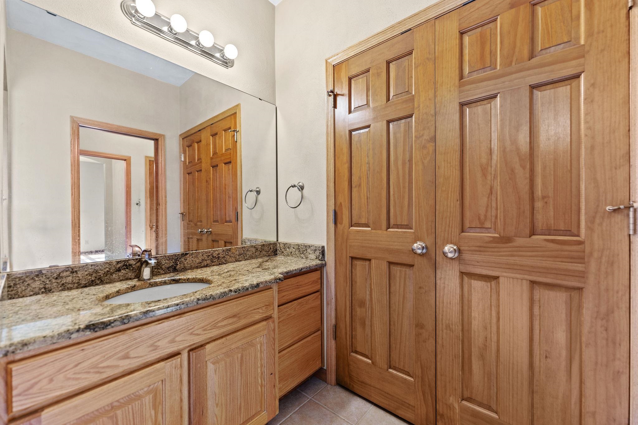 12830 Beloit Road Caledonia, IL 61011 - Photo 33 of 52 a bathroom with a granite countertop sink and a mirror