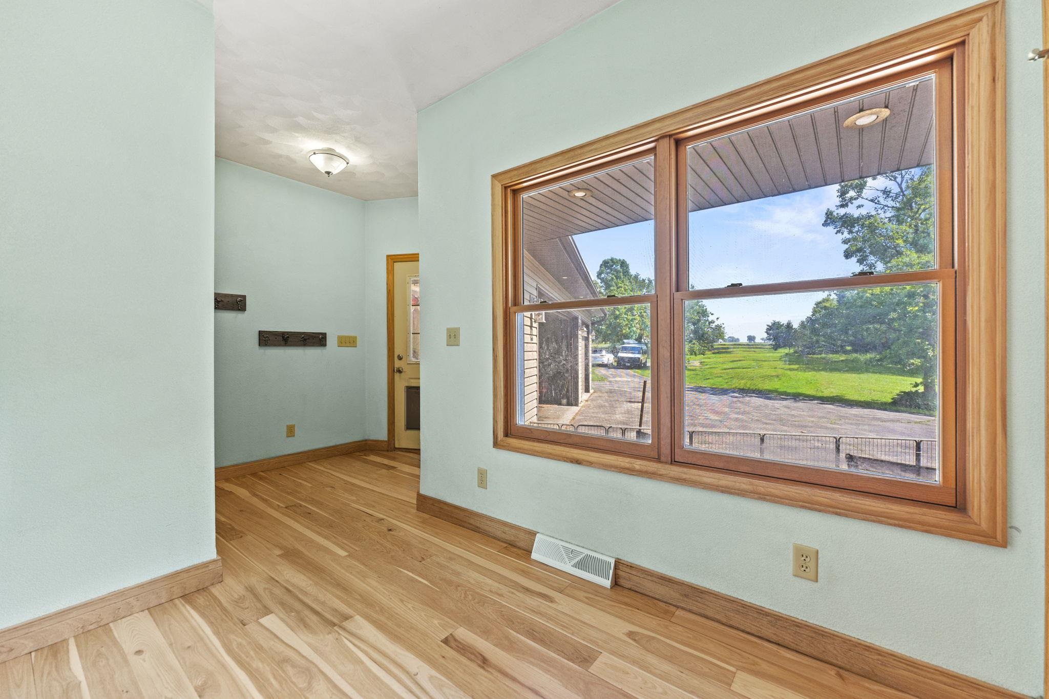 12830 Beloit Road Caledonia, IL 61011 - Photo 39 of 52 an empty room with wooden floor and a window