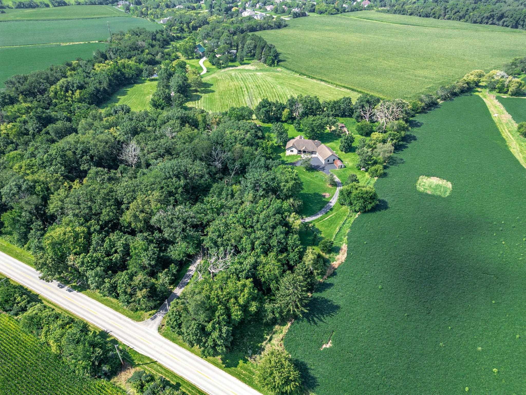 12830 Beloit Road Caledonia, IL 61011 - Photo 5 of 52 a view of a garden with a building in the background
