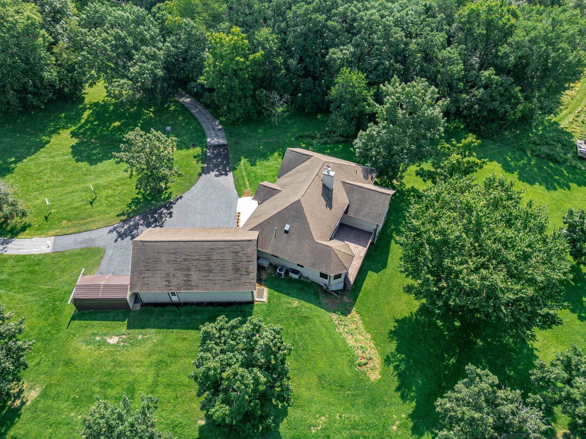 12830 Beloit Road Caledonia, IL 61011 - Photo 51 of 52 an aerial view of a house with a garden and a trees