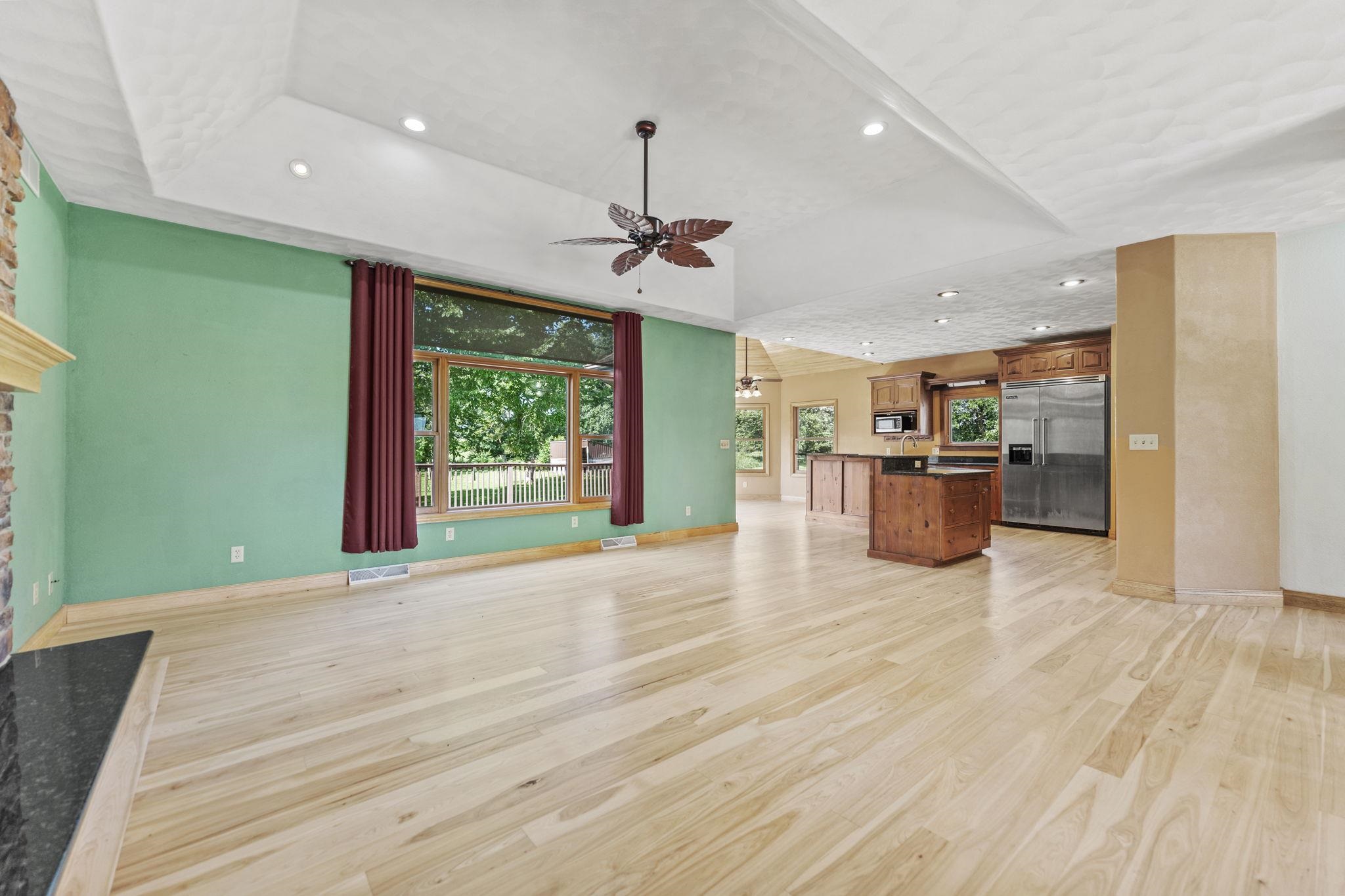 12830 Beloit Road Caledonia, IL 61011 - Photo 10 of 52 a open kitchen with stainless steel appliances granite countertop a refrigerator a stove and a wooden floors