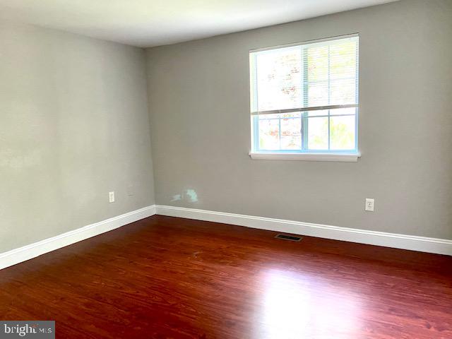 19002 Quail Valley Boulevard Gaithersburg, MD 20879 - Photo 11 of 35 an empty room with wooden floor and windows