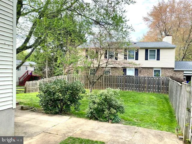 a view of a house with a tree beside it