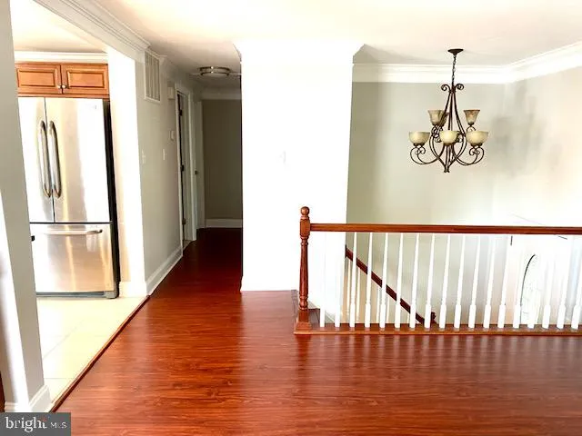 a picture of a room with wooden floor and windows