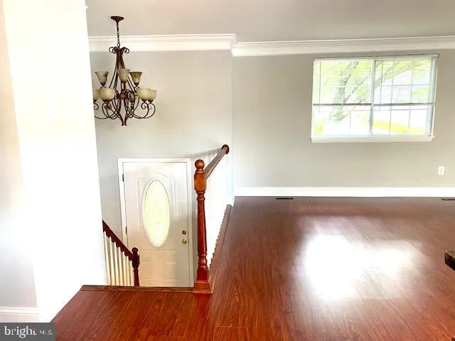 a view of a room with wooden floor and windows