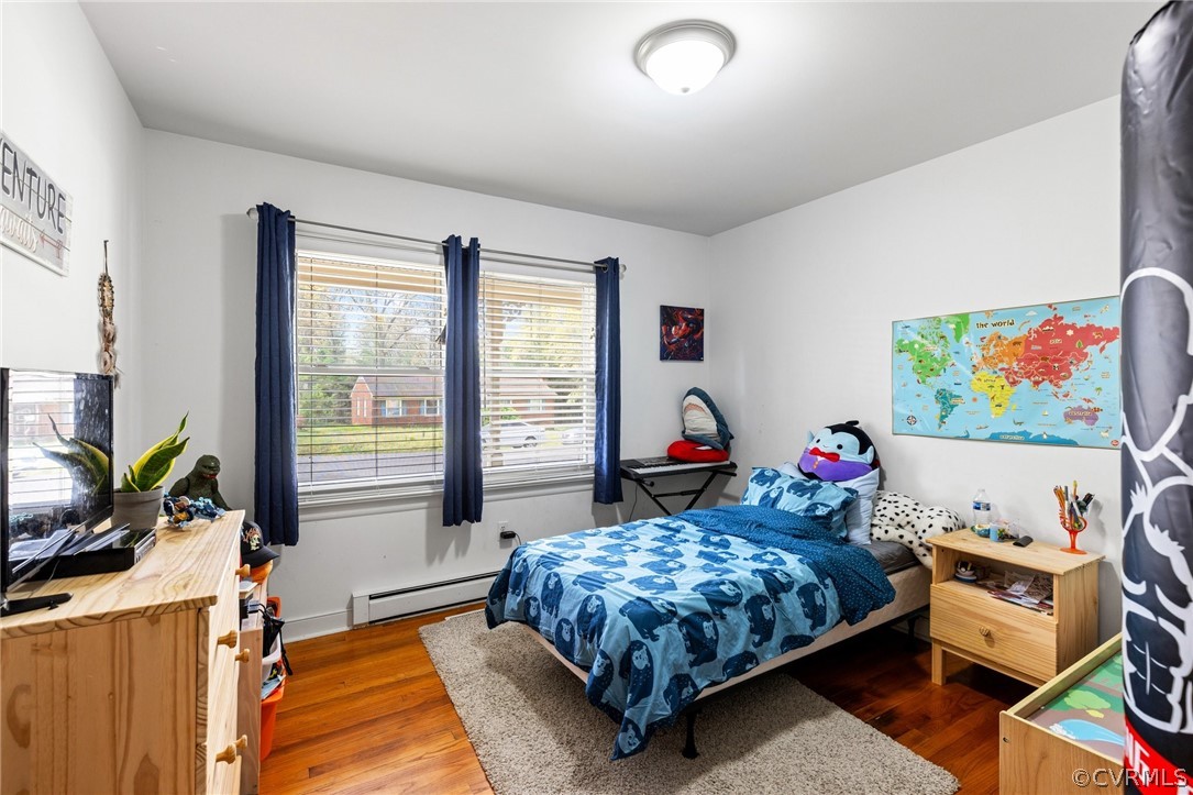 4840 Vestry Road North Chesterfield, VA 23237 - Photo 14 of 38 a bedroom with a bed a dresser next to a window
