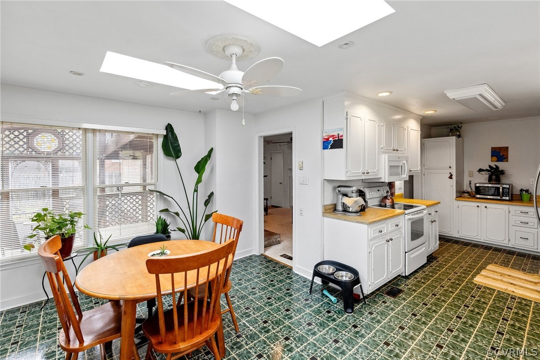 4840 Vestry Road North Chesterfield, VA 23237 - Photo 36 of 38 a kitchen with stainless steel appliances kitchen island granite countertop a table chairs in it and a window