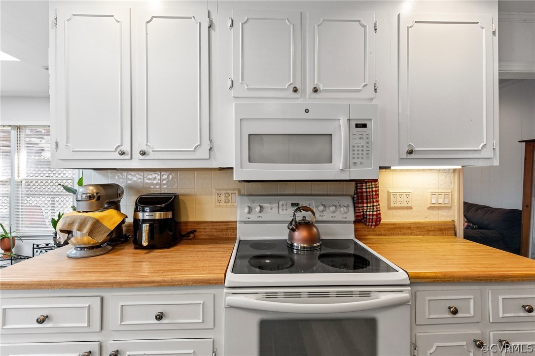 4840 Vestry Road North Chesterfield, VA 23237 - Photo 38 of 38 a kitchen with white cabinets and appliances