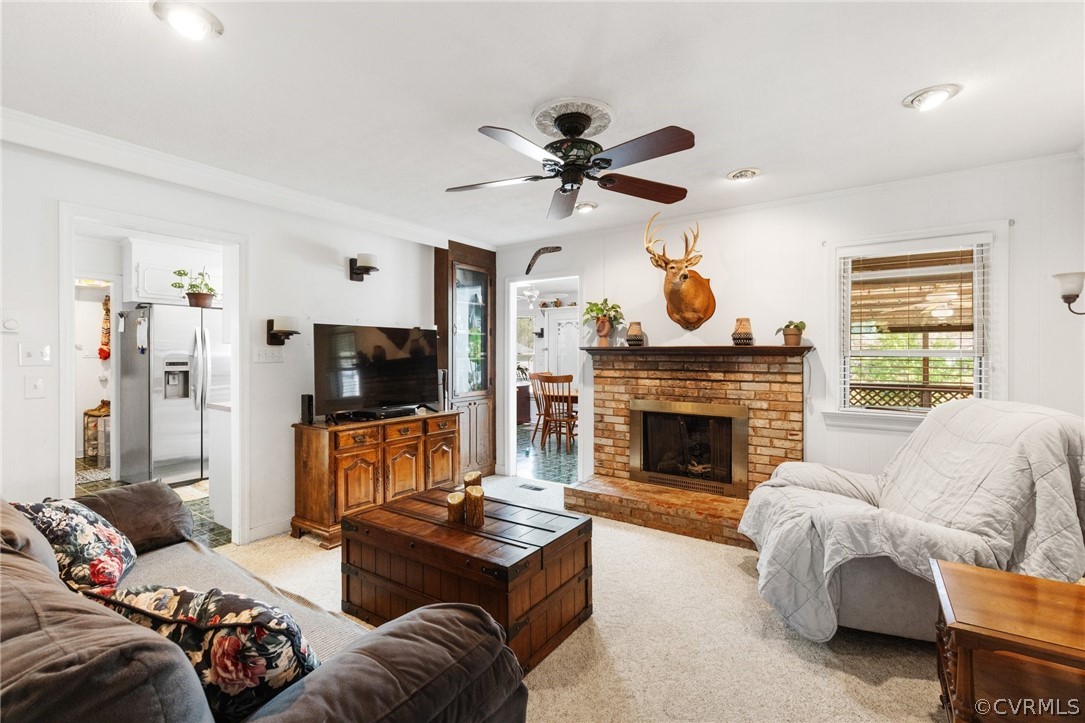 4840 Vestry Road North Chesterfield, VA 23237 - Photo 6 of 38 a living room with furniture a flat screen tv and a fireplace