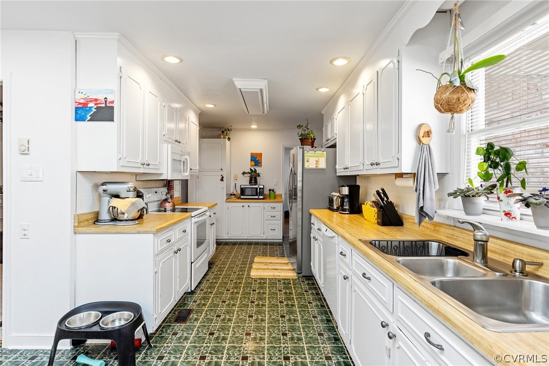 4840 Vestry Road North Chesterfield, VA 23237 - Photo 8 of 38 a large kitchen with a white stove top oven and sink