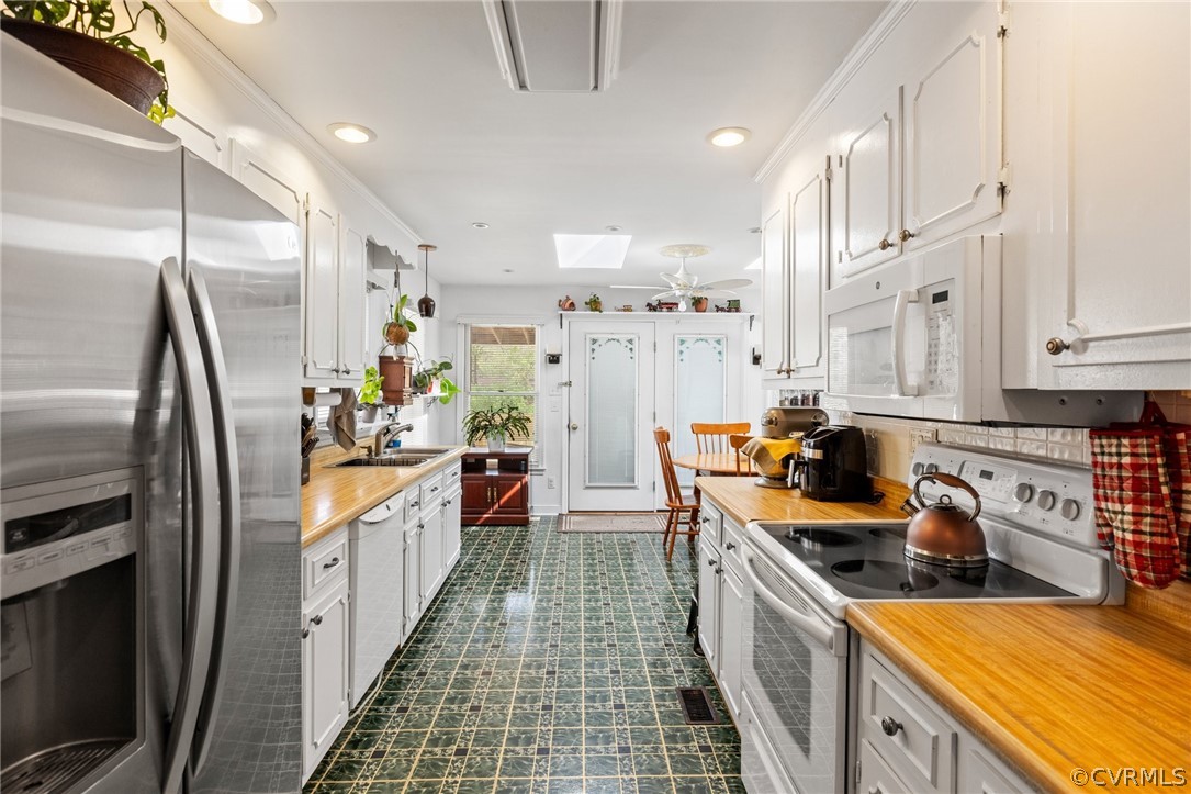 4840 Vestry Road North Chesterfield, VA 23237 - Photo 10 of 38 a kitchen with stainless steel appliances a refrigerator a sink a stove and white cabinets