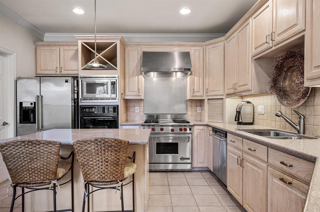 4209 Sexton Lane Dallas, TX 75229 - Photo 11 of 27 a kitchen with stainless steel appliances granite countertop a stove a sink dishwasher a refrigerator with a dining table and chairs