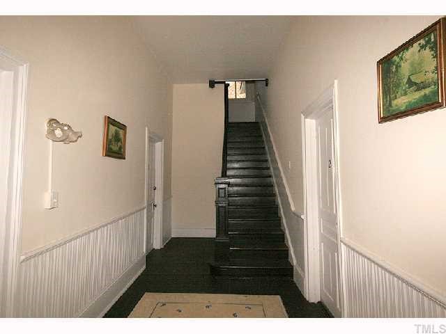 319 Lane Street Raleigh, NC 27601 - Photo 3 of 4 a view of a hallway with wooden floor and stairs