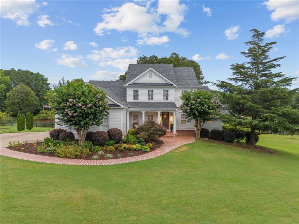 16295 Clarity Road Alpharetta, GA 30004 - Photo 1 of 1 a front view of a house with a garden and yard