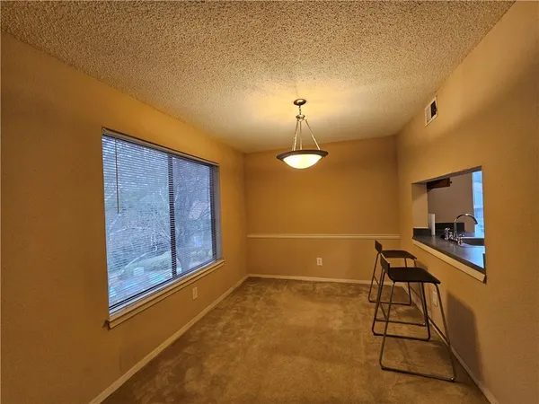 a view of an empty room and fire place