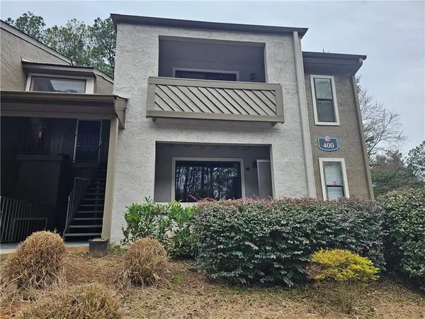 a view of a chair and tables in the backyard