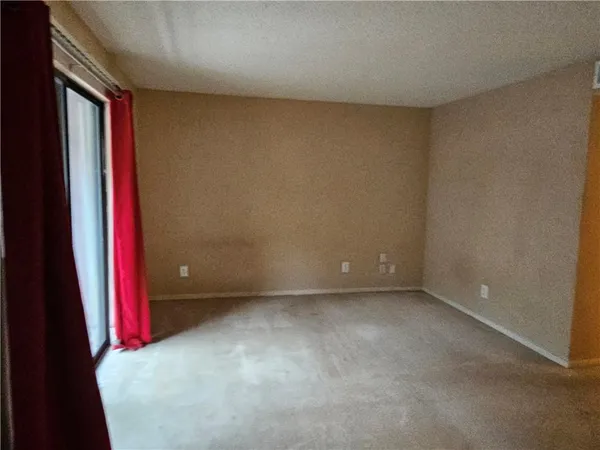 a view of a room with air conditioner and a window