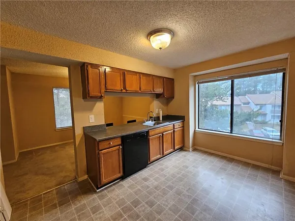 a bathroom with a sink a toilet a mirror and shower