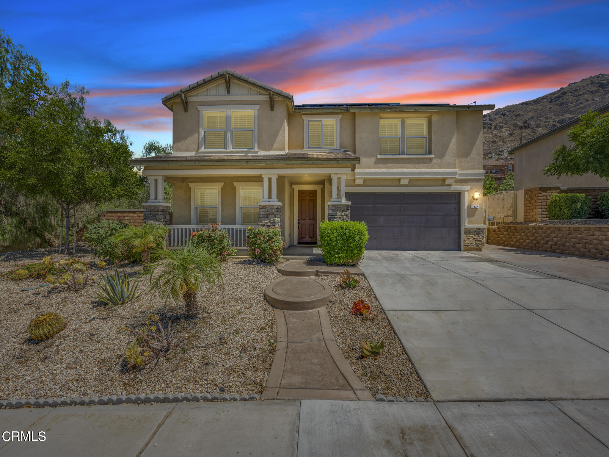 a front view of a house with garden